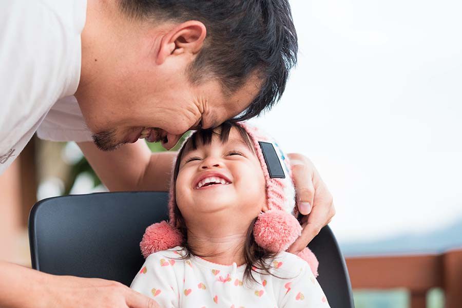 About Our Agency - Father and Daughter Hugging and Laughing Together at Home